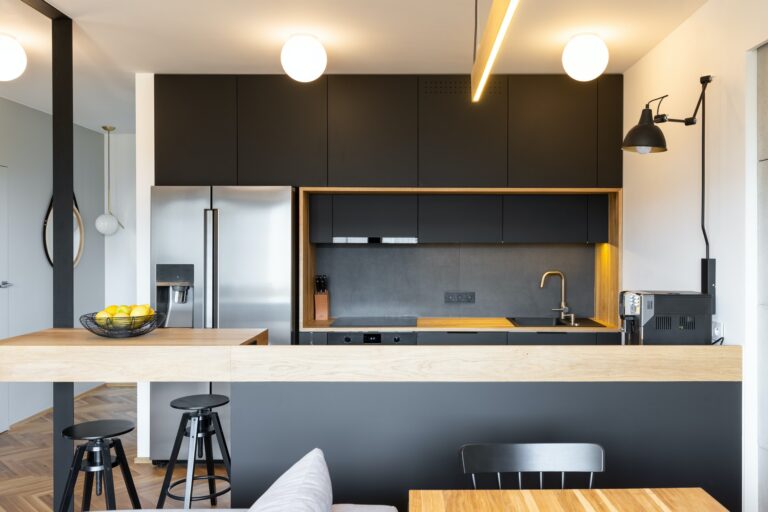 black-wooden-furniture-and-an-industrial-lamp-above-a-coffee-mac.jpg